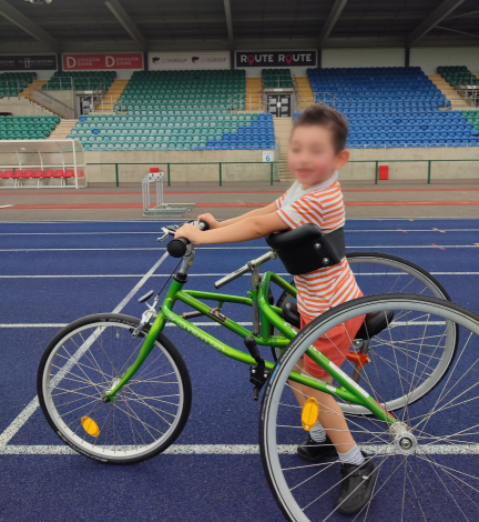 child on frame runner on thletic track